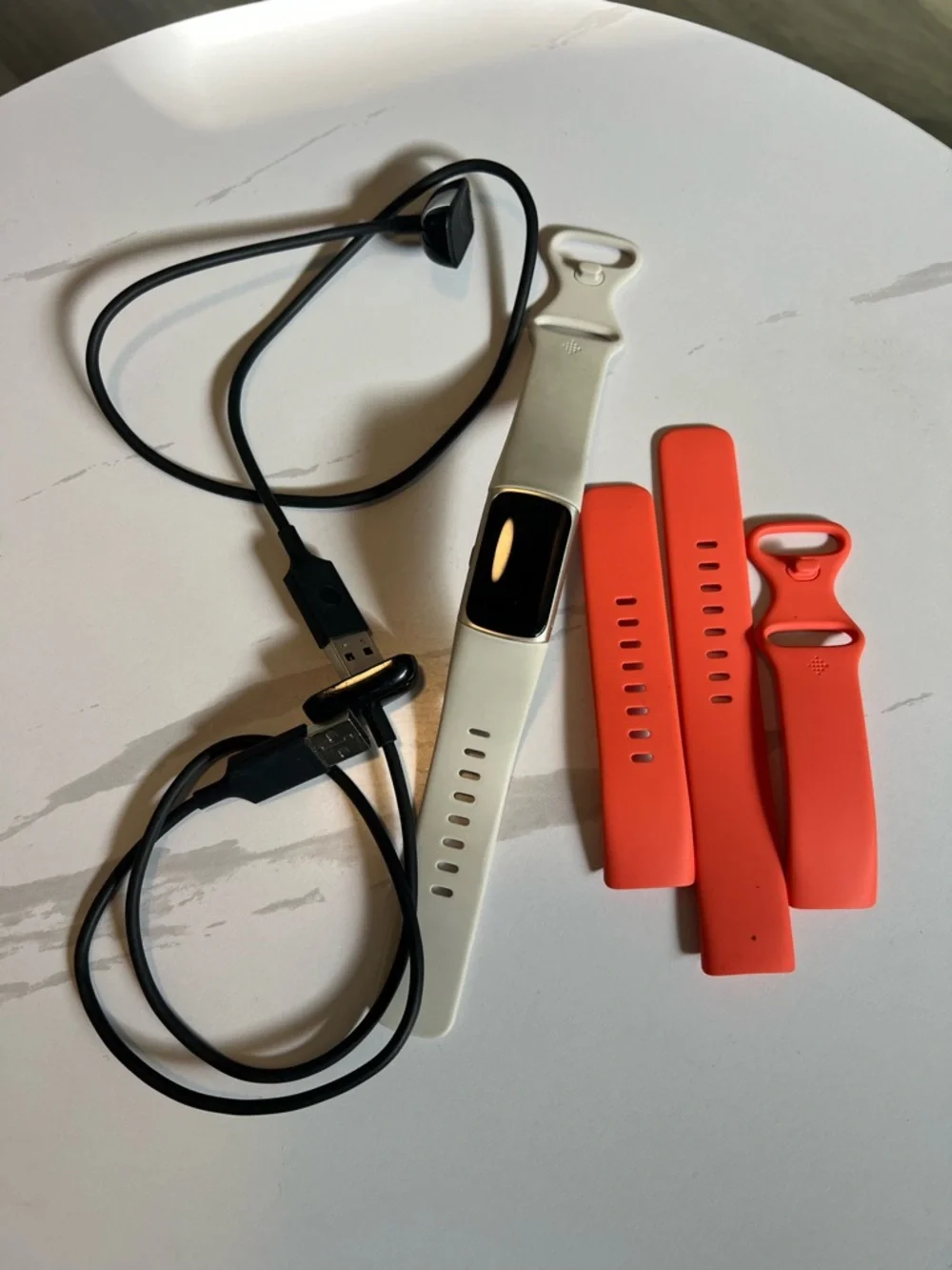 Google Fitbit Charge 6 Color: Coral/Champagne Gold Aluminum White bands Charger